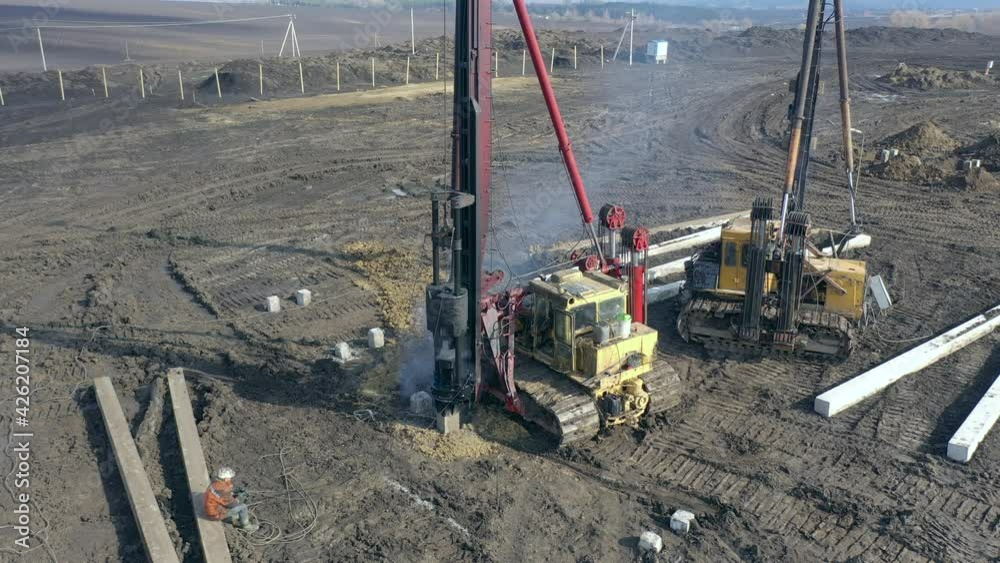 Excavation at a construction site, diesel pile driving machine with ...