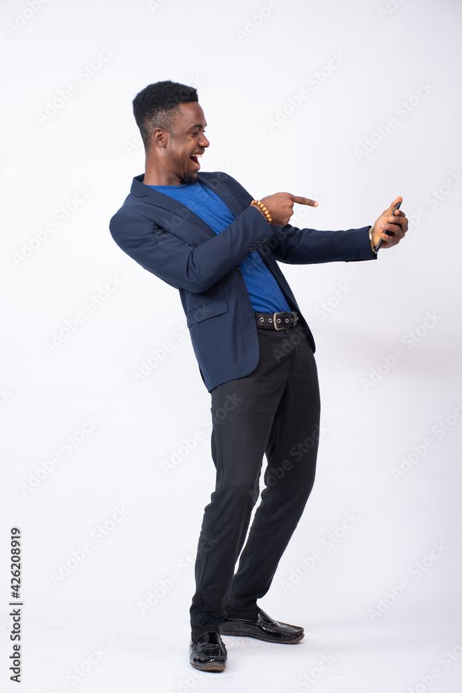 young black businessman points to his phone in excitement