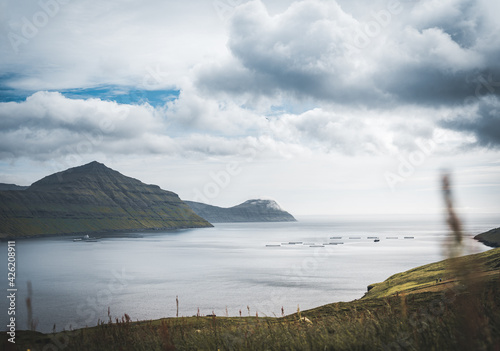 Outstanding panorama of Faroese Island cliffs and ocean mirror. Eysturoy, Faroe Islands, Denmark.