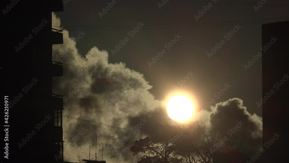 Sun and dense black smoke. 4K.
