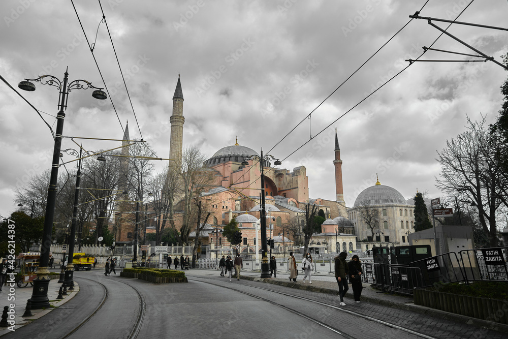 Fototapeta premium 04.03.2021. Turkey istanbul. Hagia sophia (ayasofya) mosque, church, or museum under huge clouds. Many tourist or people standing in front of old ancient building. Cloudscape and hagia sophia together
