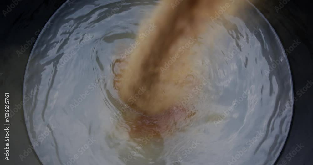 Pour Fertilizer Magnesium Sulphate mix in a black tank, Blurred moving water spins, for industry hydroponics for vegetable growing. Pour Fertilizer Magnesium Sulphate mix in a black tank, Blurred moving water spins, for industry hydroponics for vegetable growing.