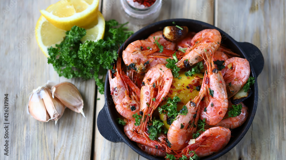 Shrimp in shells in a frying pan. Delicious fried prawns with spices. Shrimp in shells in a frying pan. Delicious fried prawns with spices.