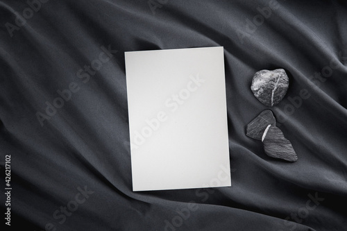 Blank greeting card or invitation mock-up on dark grey cloth