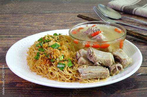 Stir fried rice noodles served with pork ribs soup, famous Phuket food photo