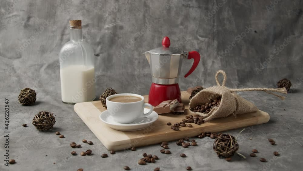 Coffee cup with natural steam smoke of coffee on dark background with copy space. Hot Coffee Drink Concept.  motion of coffee pour into cup from geyser coffee maker. Pouring black coffee in cup. Cup o