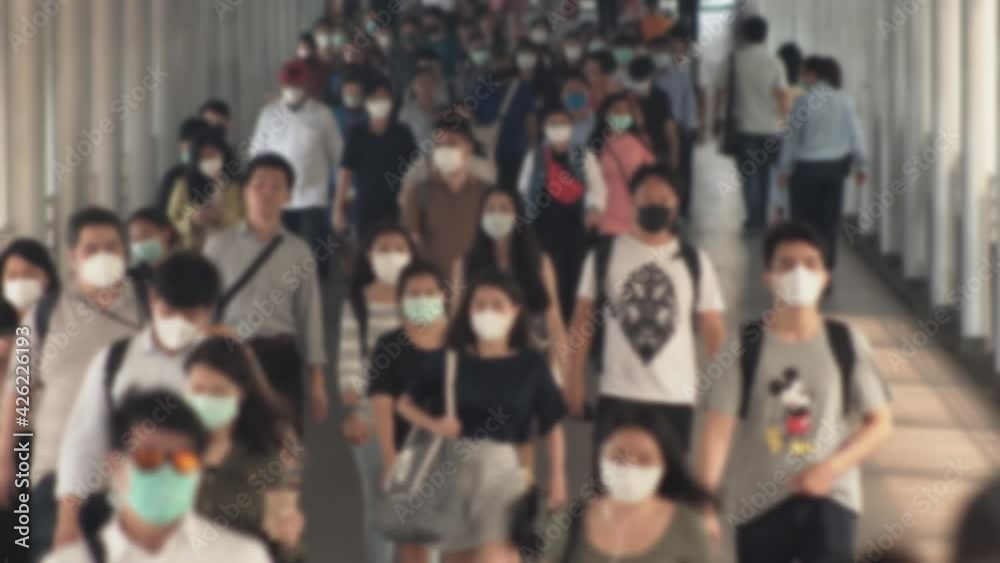 4K, Blurred defocused view of Concept of coronavirus quarantine, MERS-Cov. Large crowd of business people with medical face mask. Air pollution. 4K, Blurred defocused view of Concept of coronavirus quarantine, MERS-Cov. Large crowd of business people with medical face mask. Air pollution.