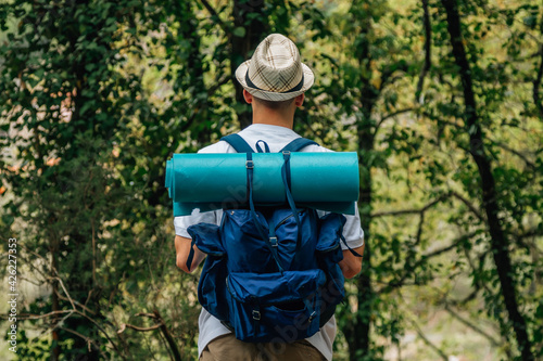 young man with backpack in nature