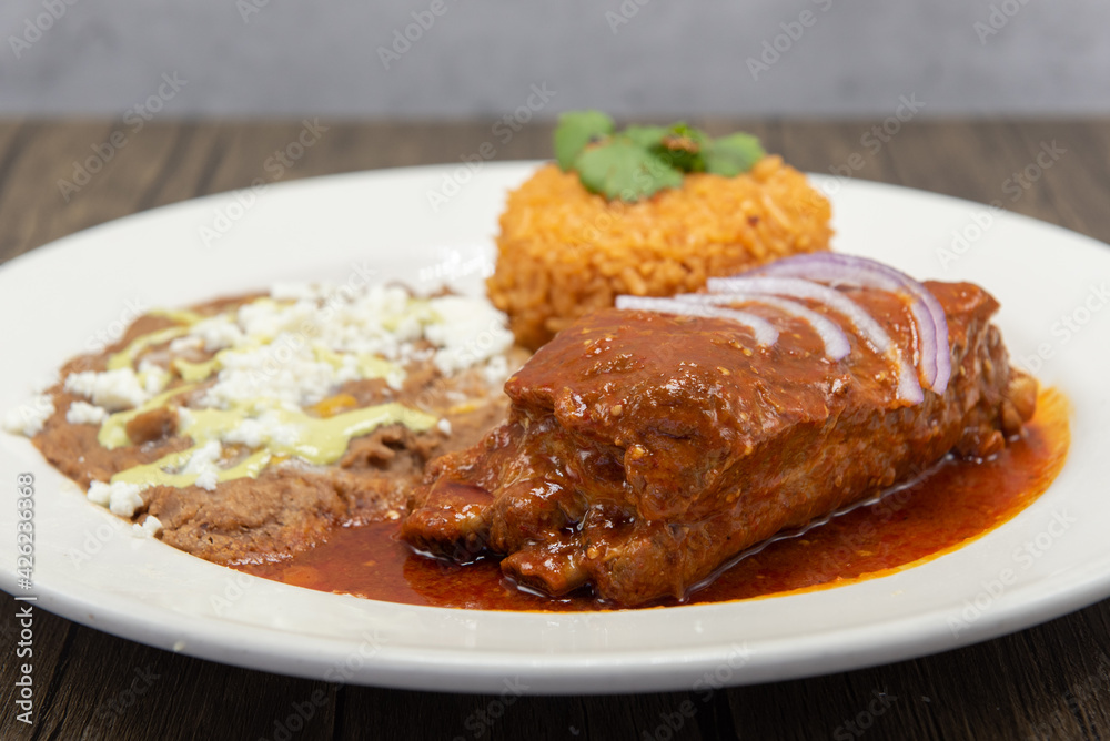 Large slap of Chile Colorado entree meat, refried beans, and rice drenched in the red sauce. Large slap of Chile Colorado entree meat, refried beans, and rice drenched in the red sauce.