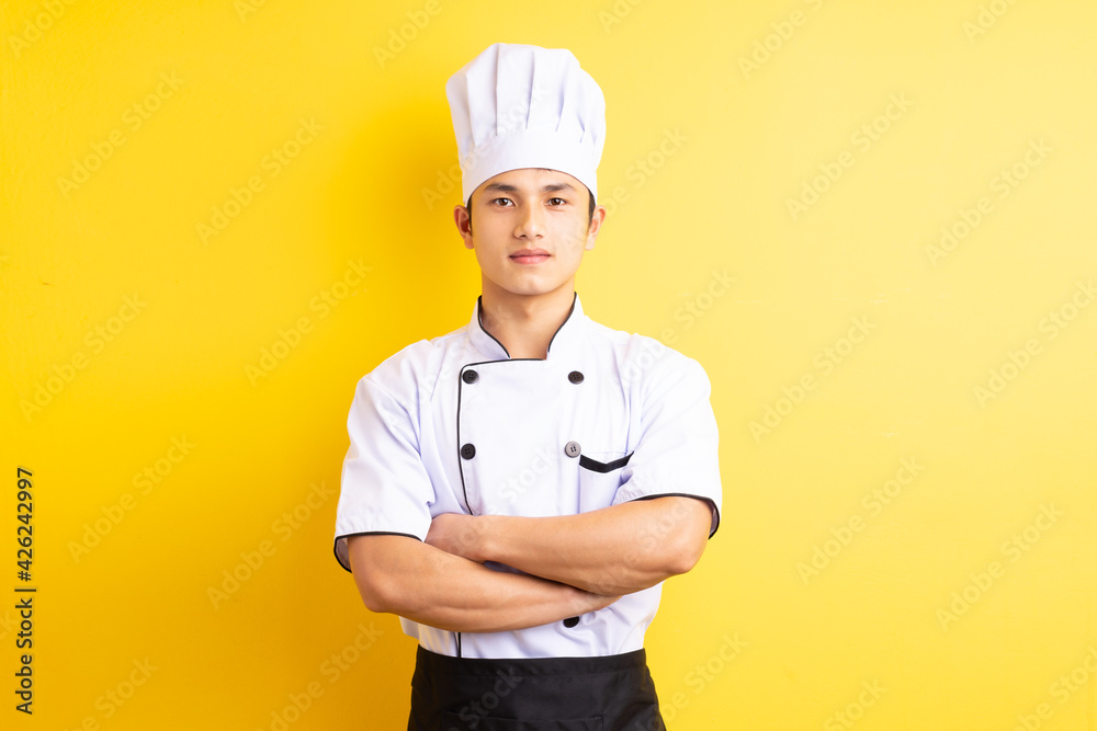 Image of Asian male chef on yellow background Image of Asian male chef on yellow background