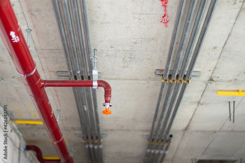 Fire sprinkler system with red pipes is placed to hanging from the