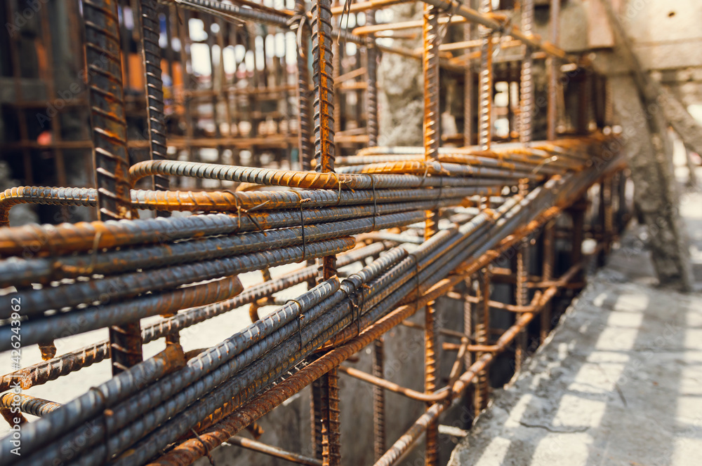 Construction steel rods or bars work reinforcement in conncrete structure of building.Background texture of steel rods used in construction to reinforce concrete Construction steel rods or bars work reinforcement in conncrete structure of building.Background texture of steel rods used in construction to reinforce concrete