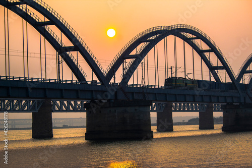Fototapeta Naklejka Na Ścianę i Meble -  The Godavari Arch Bridge is a bowstring-girder bridge that spans the Godavari River in Rajahmundry, India. It is the latest of the three bridges that span the Godavari river at Rajahmundry. 