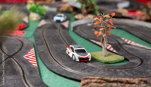 Electric slot cars on the toy race track ready to play in playroom © JackF