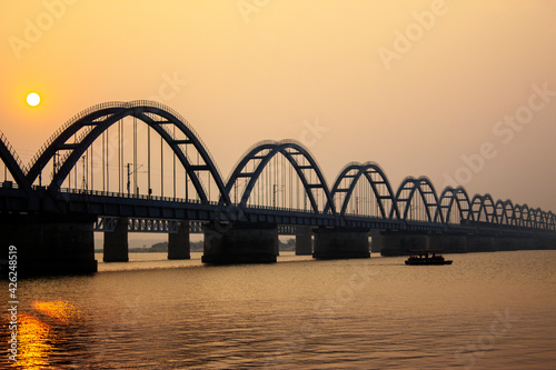 The Godavari Arch Bridge is a bowstring-girder bridge that spans the Godavari River in Rajahmundry, India. It is the latest of the three bridges that span the Godavari river at Rajahmundry.  © Veerababu