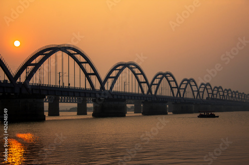 Fototapeta Naklejka Na Ścianę i Meble -  The Godavari Arch Bridge is a bowstring-girder bridge that spans the Godavari River in Rajahmundry, India. It is the latest of the three bridges that span the Godavari river at Rajahmundry. 