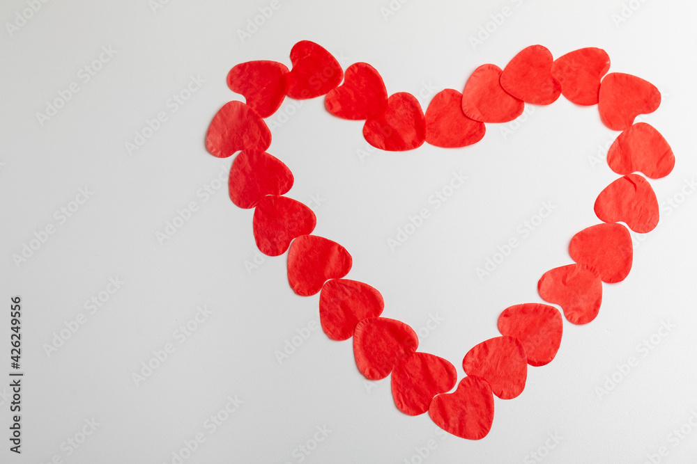 Symbol of love, human health with red paper hearts laid out in the sight of a big heart on a white background