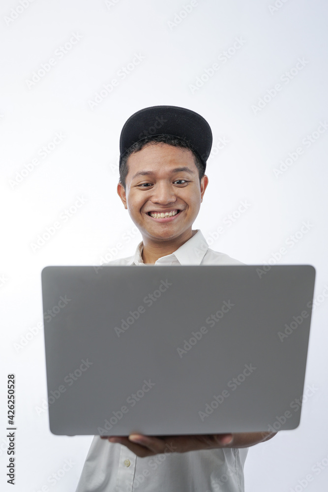 portrait of a cheerful teenager holding a laptop computer isolated in white portrait of a cheerful teenager holding a laptop computer isolated in white