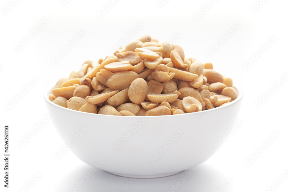 Close up of Salted Peanuts Indian namkeen (snacks) on a ceramic white bowl. Close up of Salted Peanuts Indian namkeen (snacks) on a ceramic white bowl.