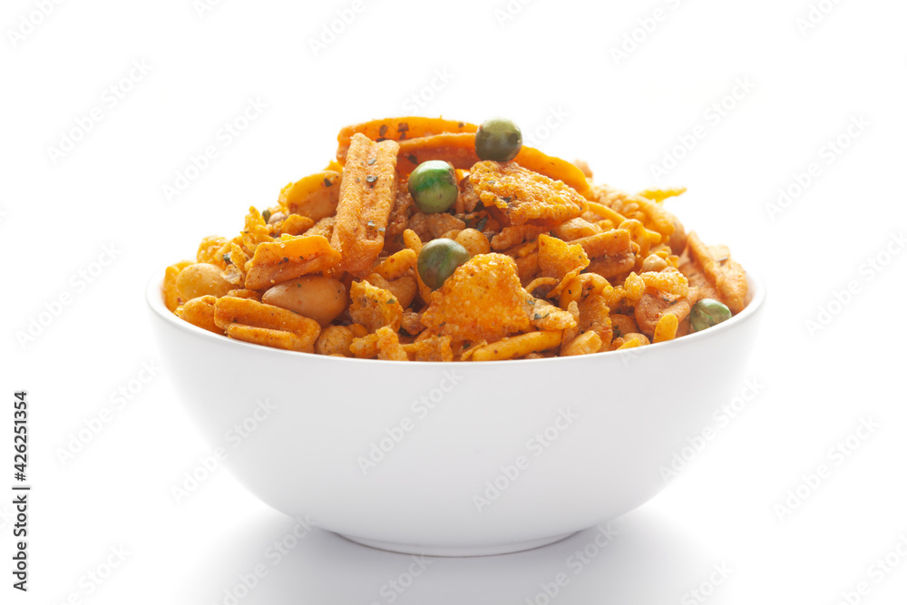 Close up of Teekha Meetha crunchy spicy Indian namkeen (snacks) on a ceramic white bowl. Close up of Teekha Meetha crunchy spicy Indian namkeen (snacks) on a ceramic white bowl.