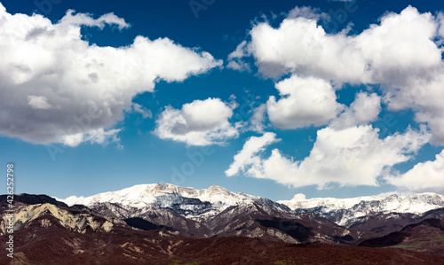 Cloud over snow capped mountain peaks © Vastram