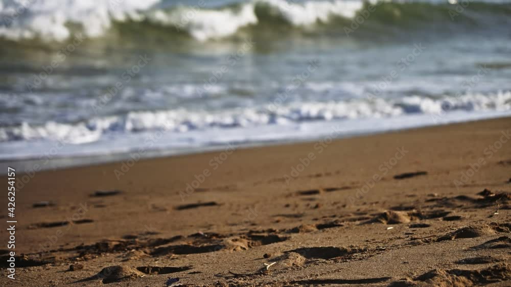 Dark day at the beach with focus shifting from the sand into the sea Dark day at the beach with focus shifting from the sand into the sea