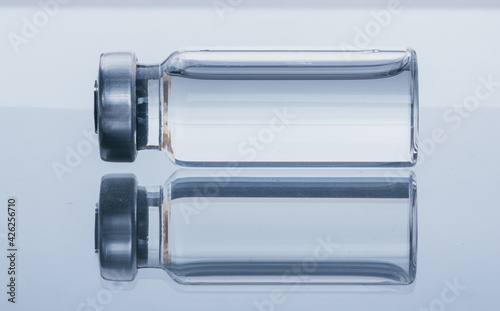 Glass medical ampoule vial for injection. Medicine is dry white drug penicillin powder or liquid with of aqueous solution in ampulla. Close up.