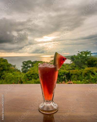 Watermelon cocktail in a sunset background