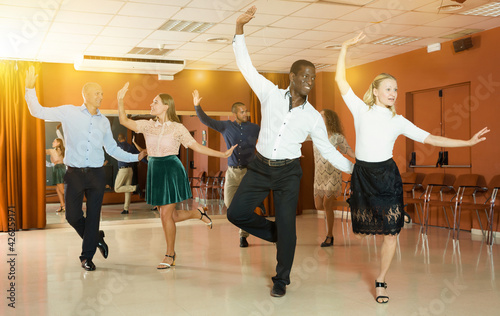 Canvas-taulu Young positive people dancing tap dance in pairs in studio..