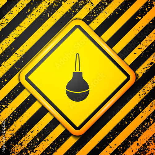 Black Enema icon isolated on yellow background. Enema with a plastic tip. Medical pear. Warning sign. Vector