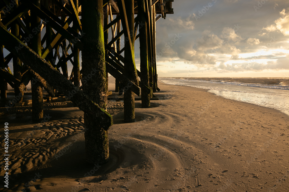 Historical stilt house at the wide sandy beach of the popular seaside resort of St. Peter Ording