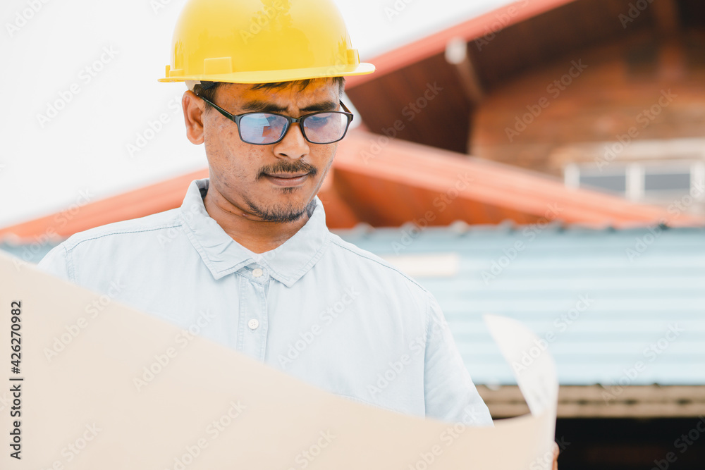 Engineers or field businessmen Planning on construction plans for a pleasant house project Engineers or field businessmen Planning on construction plans for a pleasant house project