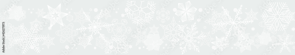 Light gray horizontal seamless header with snowflakes of different shapes, sizes 