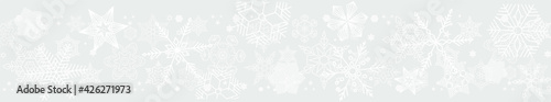 Light gray horizontal seamless header with snowflakes of different shapes, sizes 