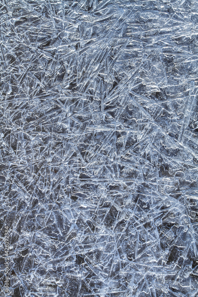 ice pattern consisting of frozen ice needles on a dark background ice pattern consisting of frozen ice needles on a dark background