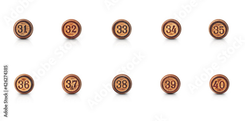 the numbers from thirty-one to forty carved in round pieces of wood are isolated on a white background with shadow and reflection photo