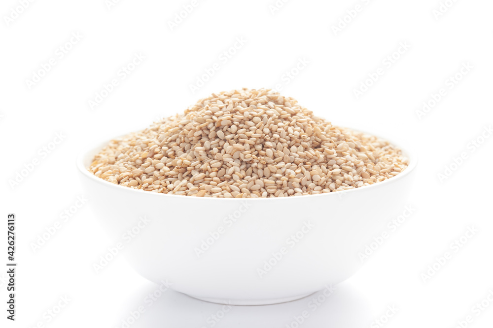 Close up of Organic White Sesame seeds(Sesamum indicum) or white Til with shell inside a white ceramic bowl Close up of Organic White Sesame seeds(Sesamum indicum) or white Til with shell inside a white ceramic bowl