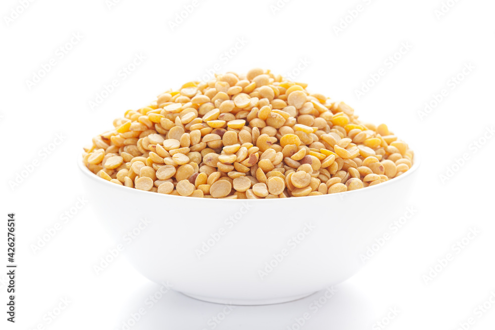  Close-up of Organic arhar dal (Cajanus cajan) or split yellow dal inside a ceramic white bowl. 