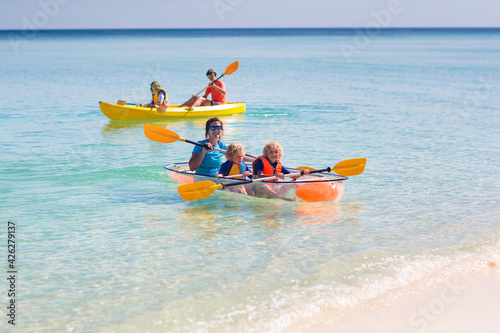 Kids kayaking in ocean. Family in kayak in tropical sea © famveldman