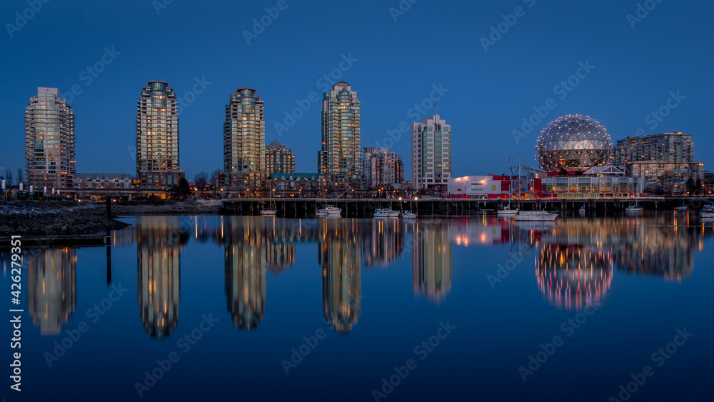 Naklejka premium Vancouver Skyline at the Blue Hour with Lights on the Science Center Globe at night on the Eastern Shore of False Creek Inlet, British Columbia, Canada