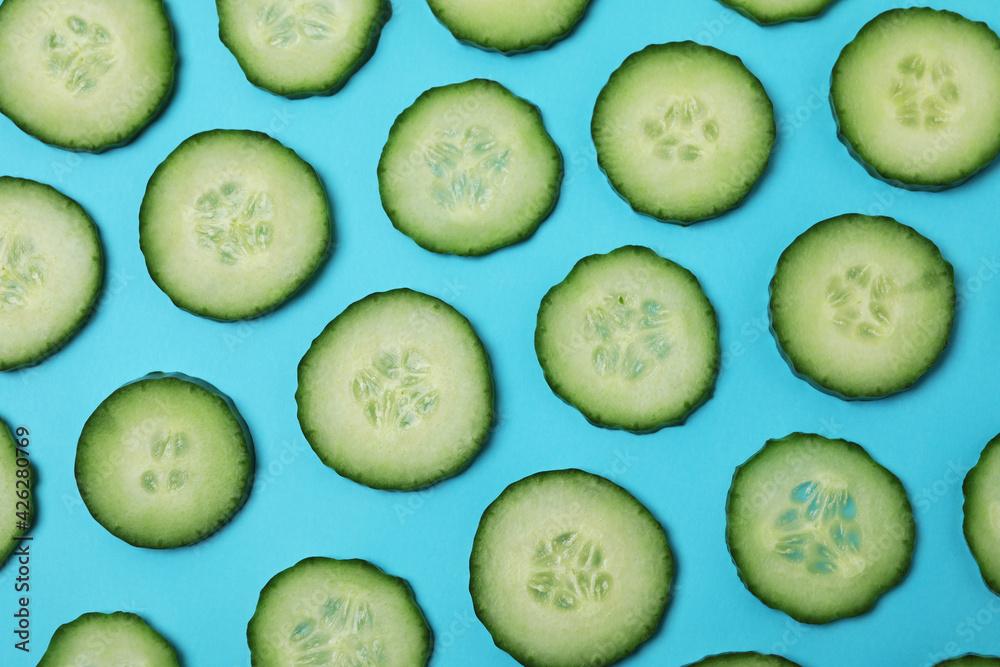 Fresh ripe cucumber slices on blue background Fresh ripe cucumber slices on blue background