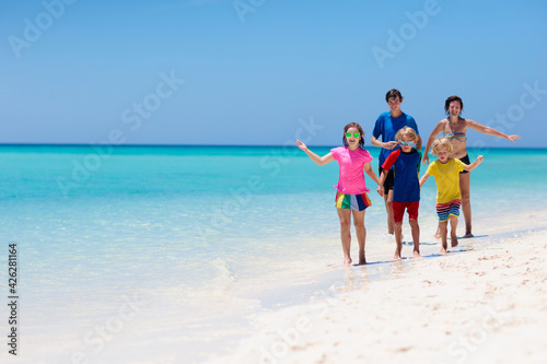 Family vacation. Parent and kids on tropical beach
