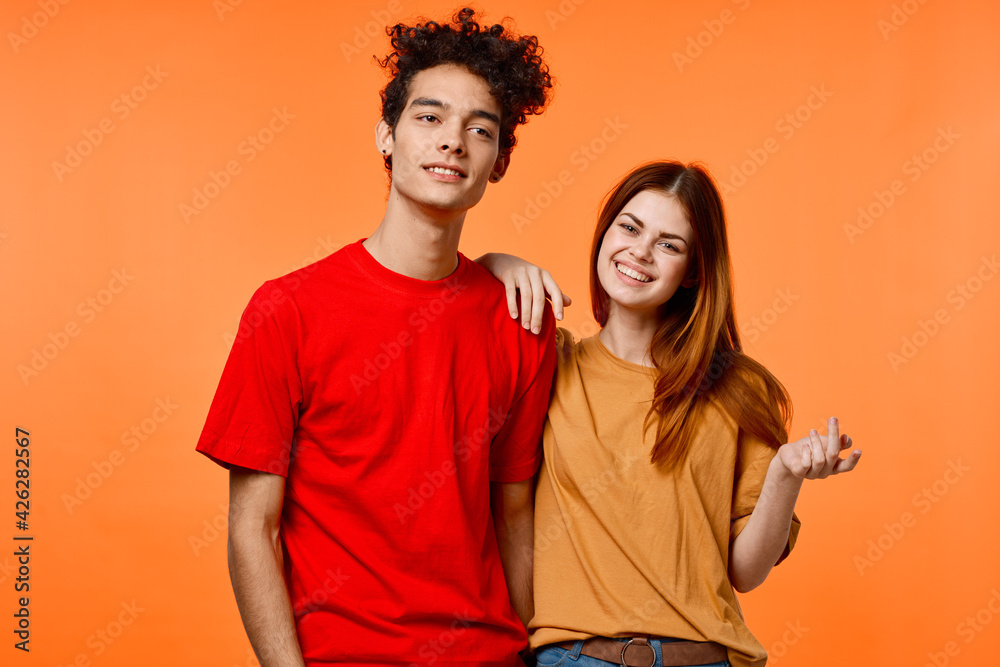 Fototapeta premium funny guy and girl in multicolored t-shirts modern style fashion