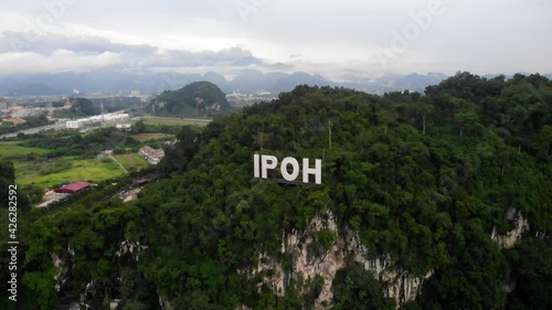 Aerial view of IPOH signage on top of a hill. Ipoh is a city in northwestern Malaysia