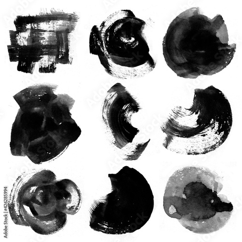 Black watercolor stains on a white background. Abstract painting, naive art. Splashes of ink.