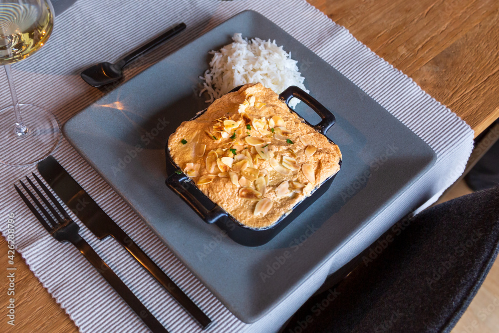 Fish in a casserole with meringue almond topping cooked in the oven with rice. Fish in a casserole with meringue almond topping cooked in the oven with rice.