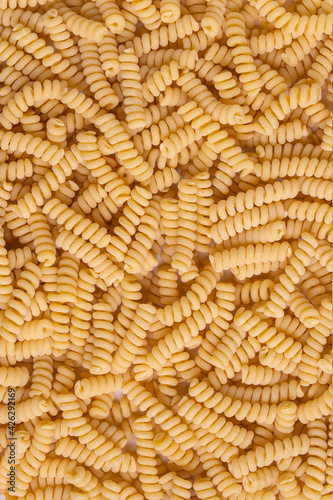 Uncooked Spiral Pasta, top view. Copy-space