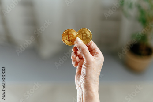 image of two bitcoins in the hands of a woman.