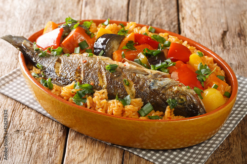 Bild auf Leinwand Senegalese rice and fish with vegetables Thieboudienne closeup in the dish on the table