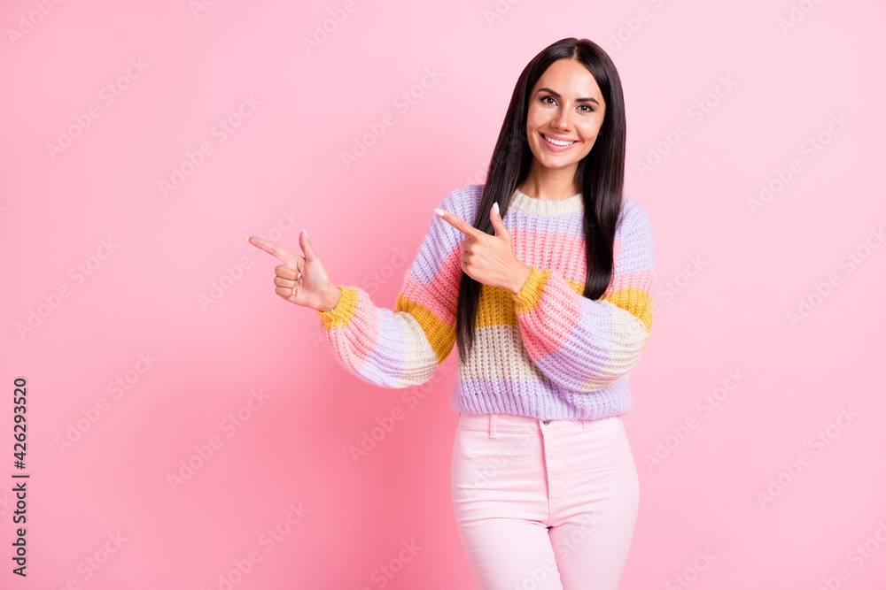 Photo of optimistic brunette nice lady point empty space wear sweater isolated on pastel pink color background Photo of optimistic brunette nice lady point empty space wear sweater isolated on pastel pink color background